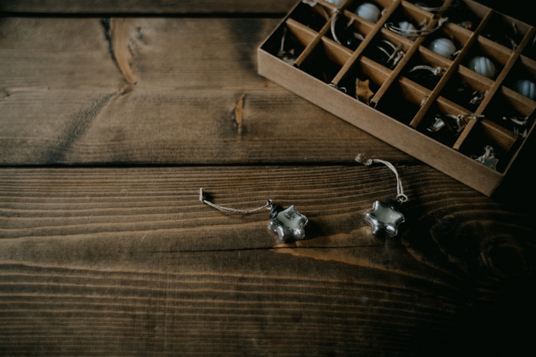 Quick Tips and Facts: Your Headphone History Cheat Sheet by Headphone Brands a pair of earrings sitting on top of a wooden table