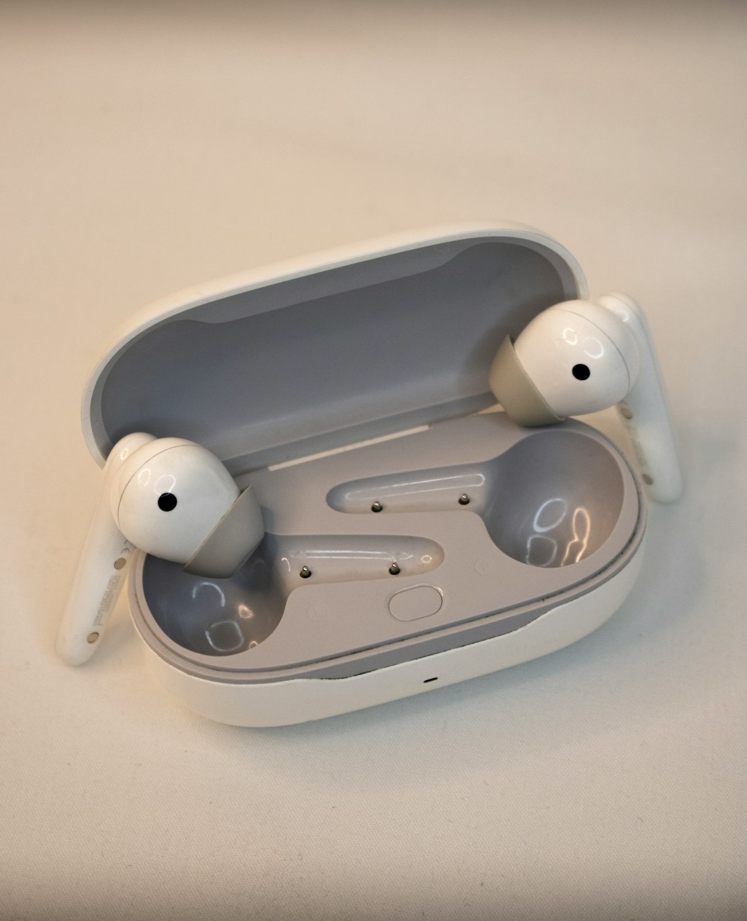 Product photograph of white wireless headphones, suitable for creating mockups and more... by Headphone Brands A pair of headphones sitting on top of a table