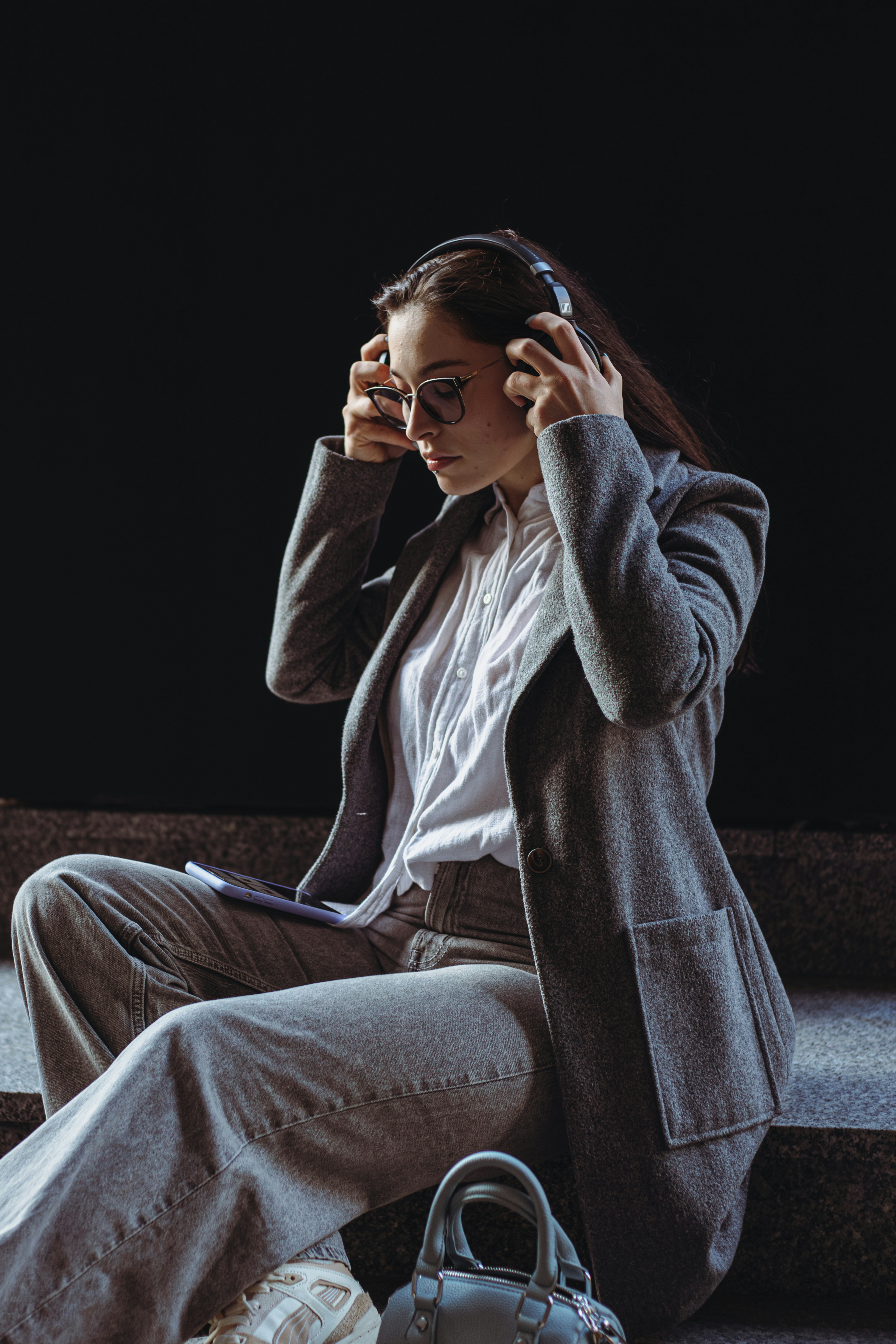 A woman sitting on steps talking on a cell phone